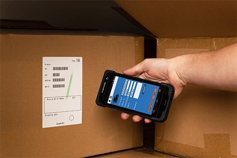 H-28 Android Mobile Computer used to scan barcodes on a box in a warehouse